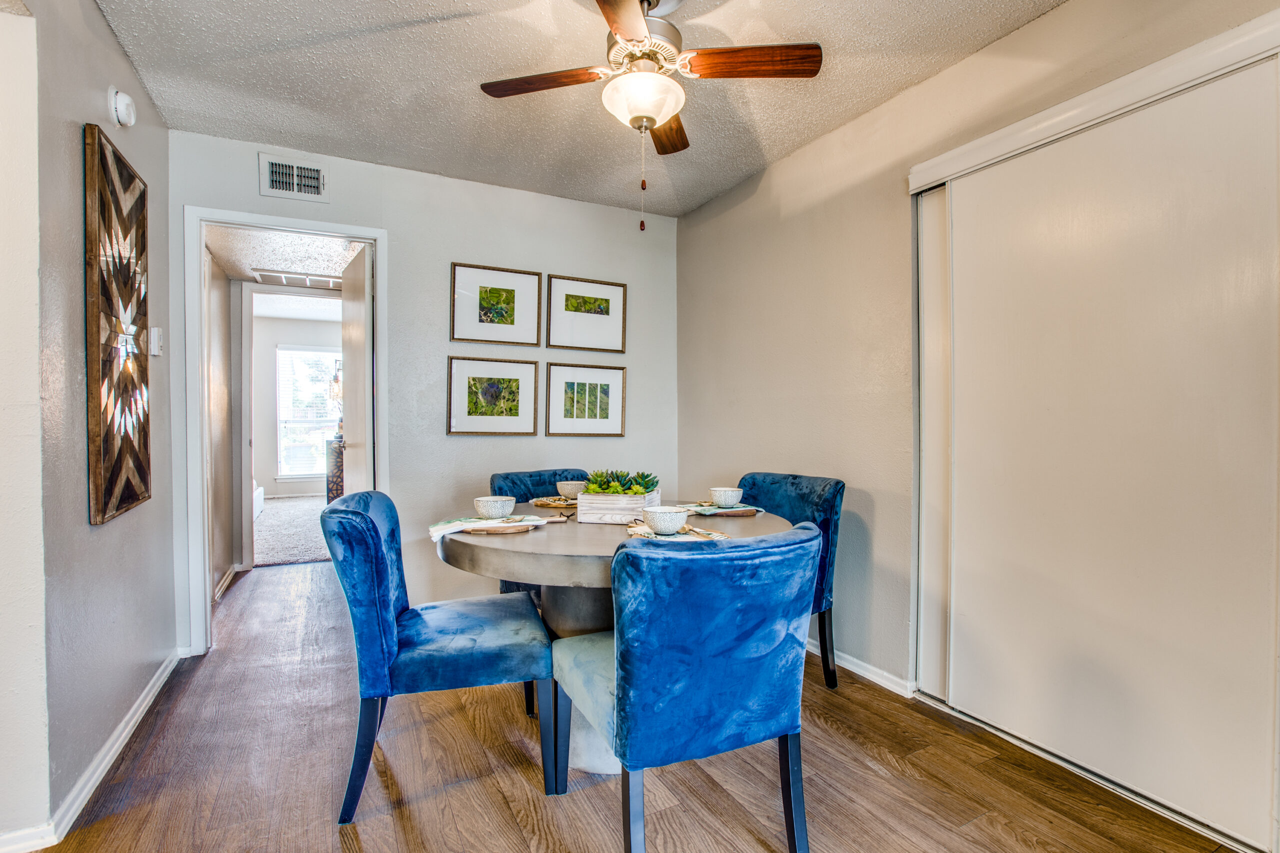 model dining room with blue chairs and ceiling fan