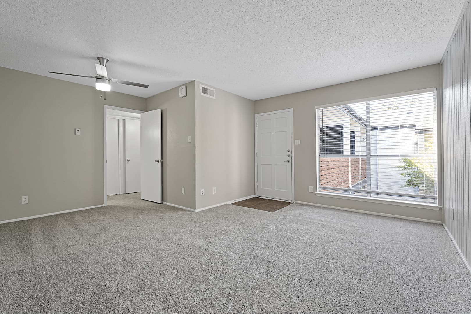 newly renovated apartment home living room with ceiling fan